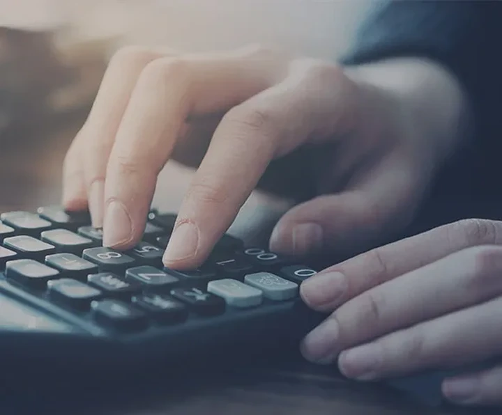 A business person operating a calculator