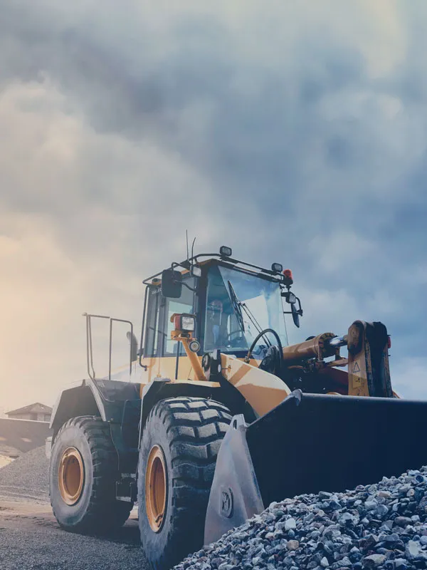 An industrial size tractor working in a stone yard