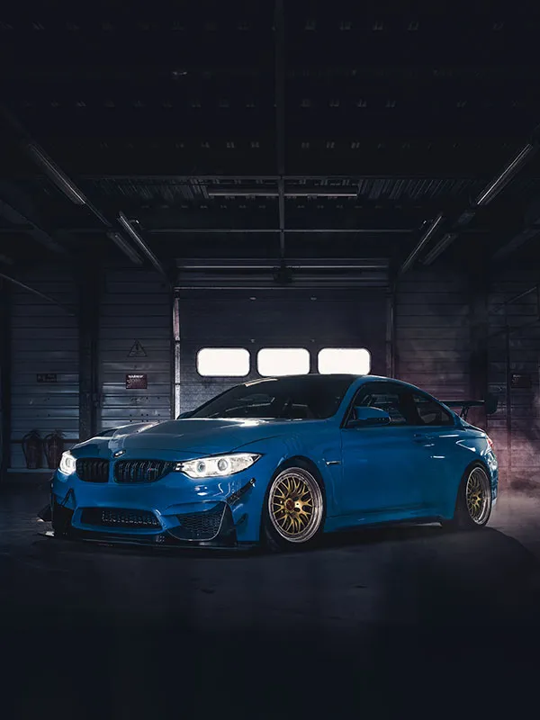 Blue BMW motor racing car in a garage